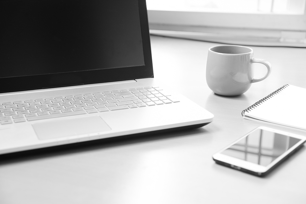 smartphone notebook paper for note message and a cup of coffee on wood desk